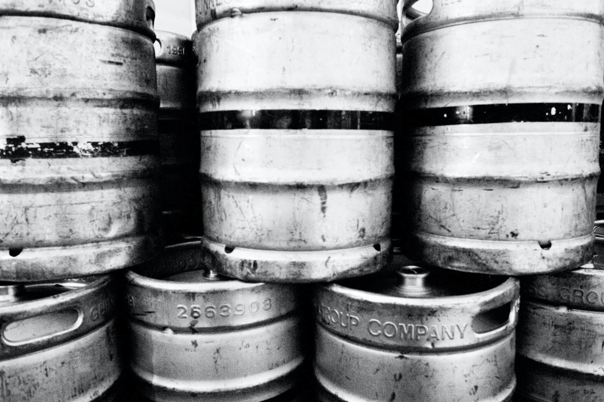 Stack of beer kegs in black and white