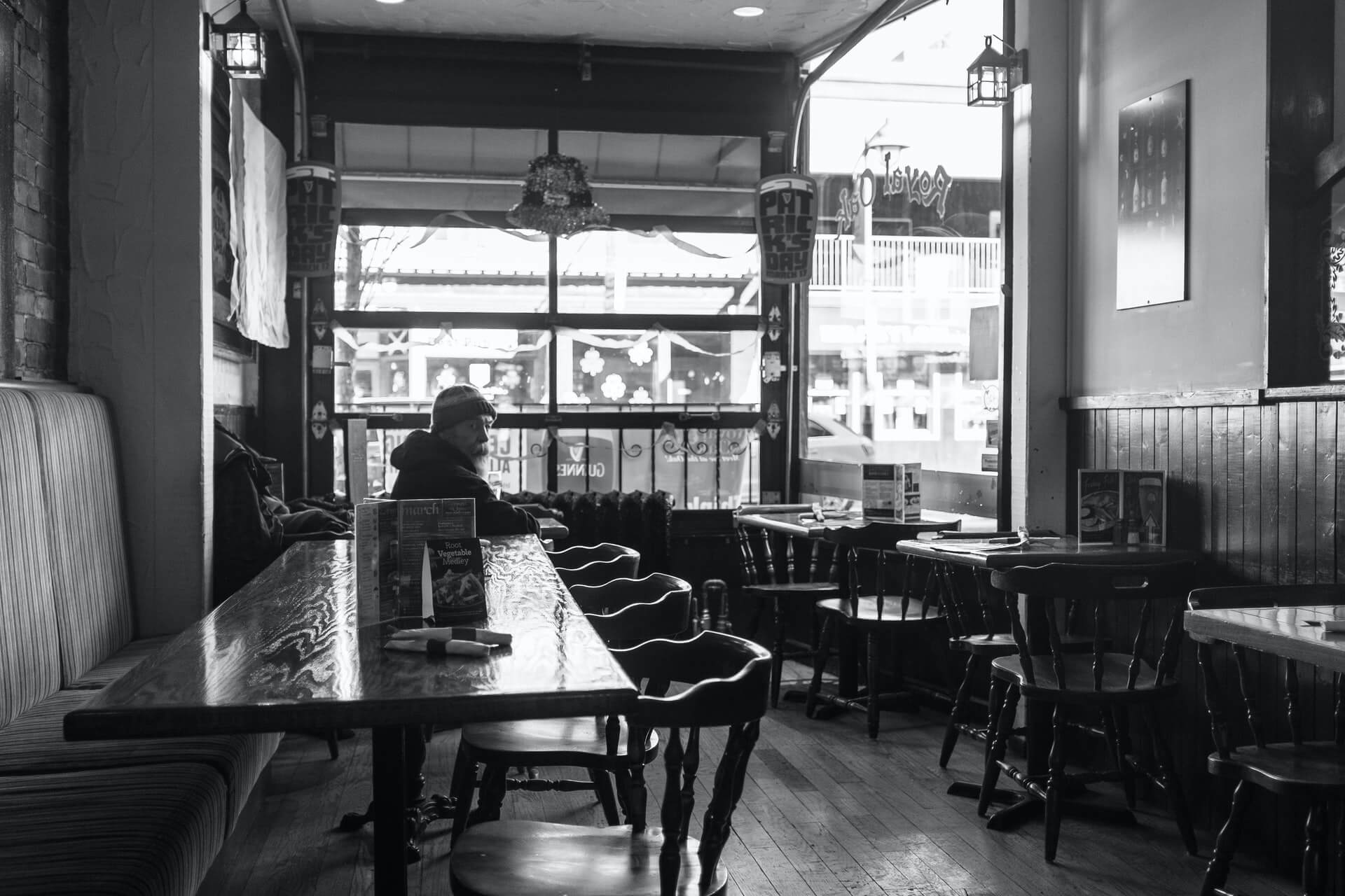 Man in empty restaurant and bar in Ottawa, Ontario, Canada