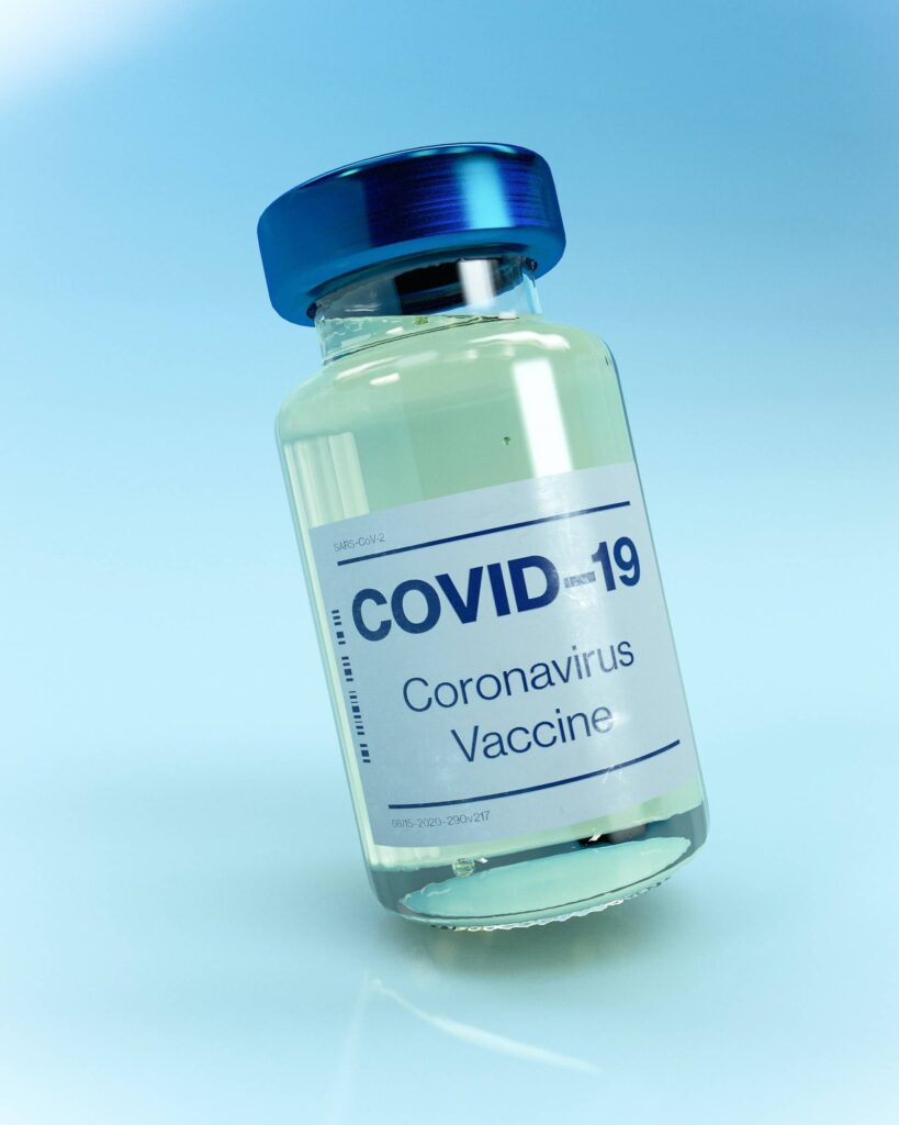 Covid-19 vaccine vial on blue background
