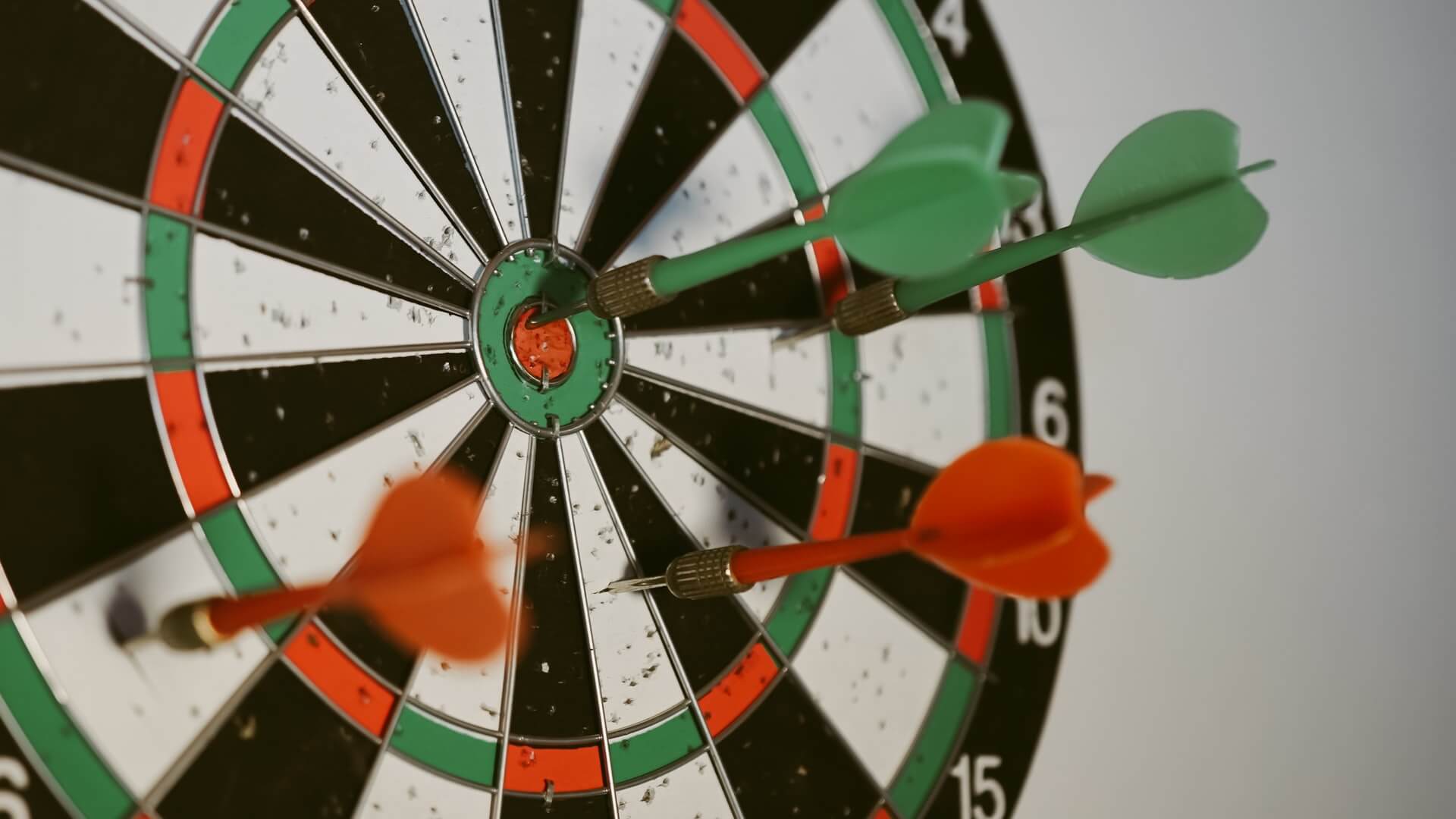 Darts in a dartboard and in bullseye