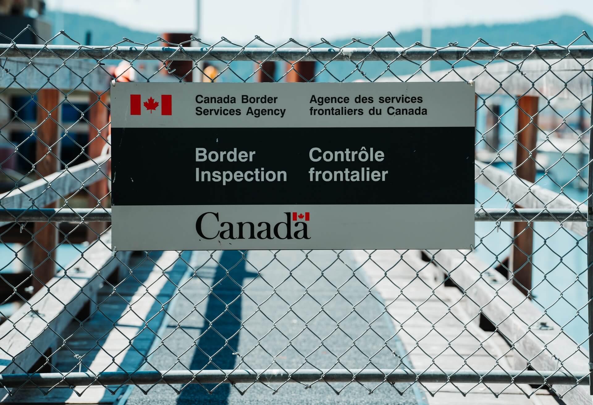 Canadian Border Services Agency sign on chainlink fence