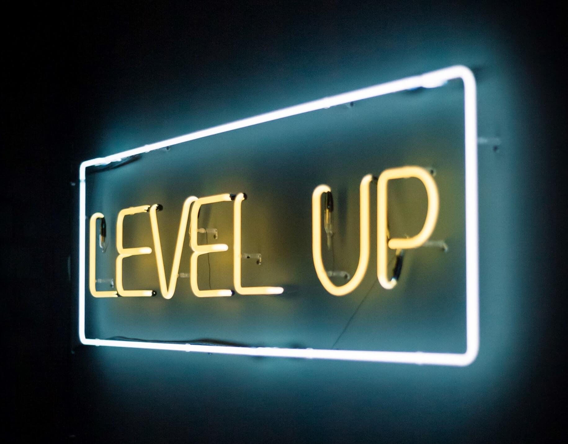 Level Up neon sign in white and yellow