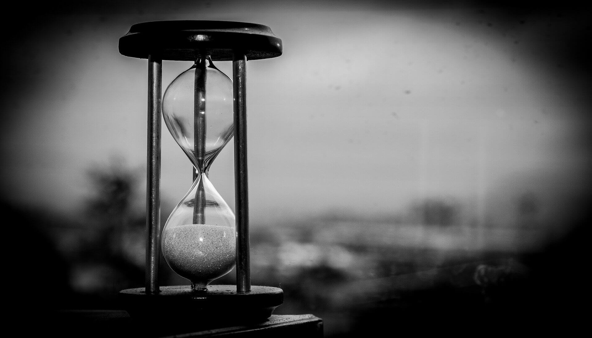 Time has run out hourglass, black and white