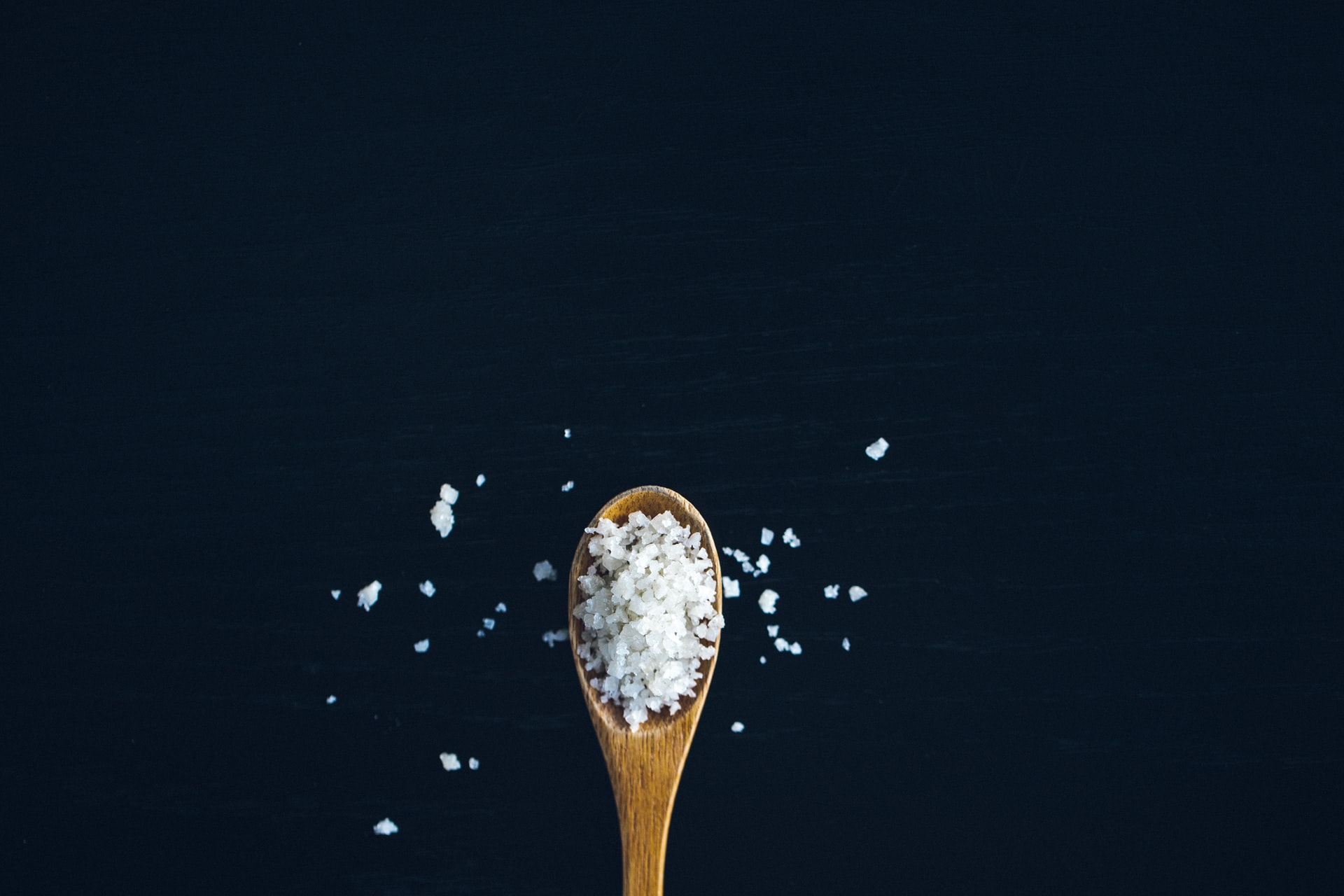 Wooden spoon loaded with salt
