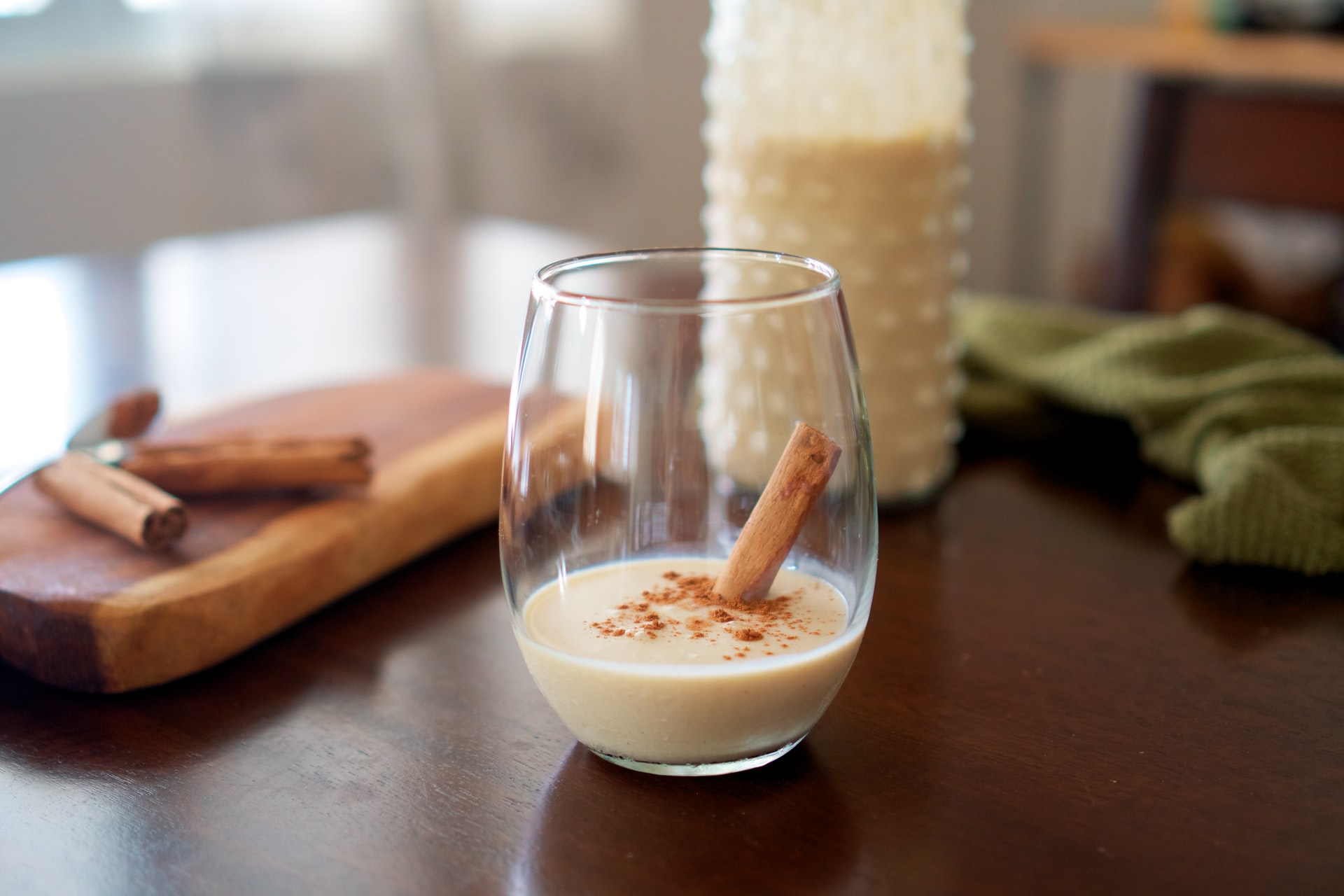 Coquito cocktail garnished with cinnamon stick