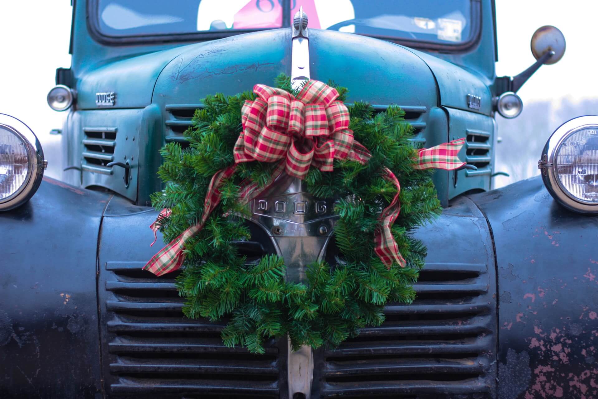 Classic vintage Dodge pickup truck with winter wreath on grille