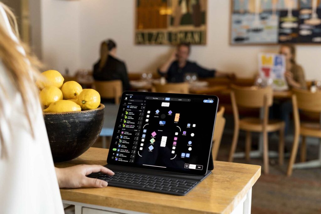 Restaurant worker using SevenRooms on tablet