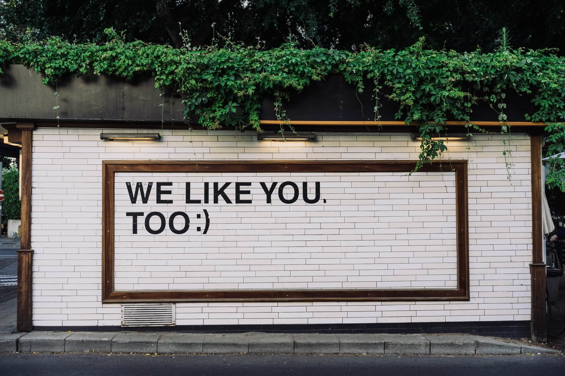 Sign on wall that reads, "We like you too"