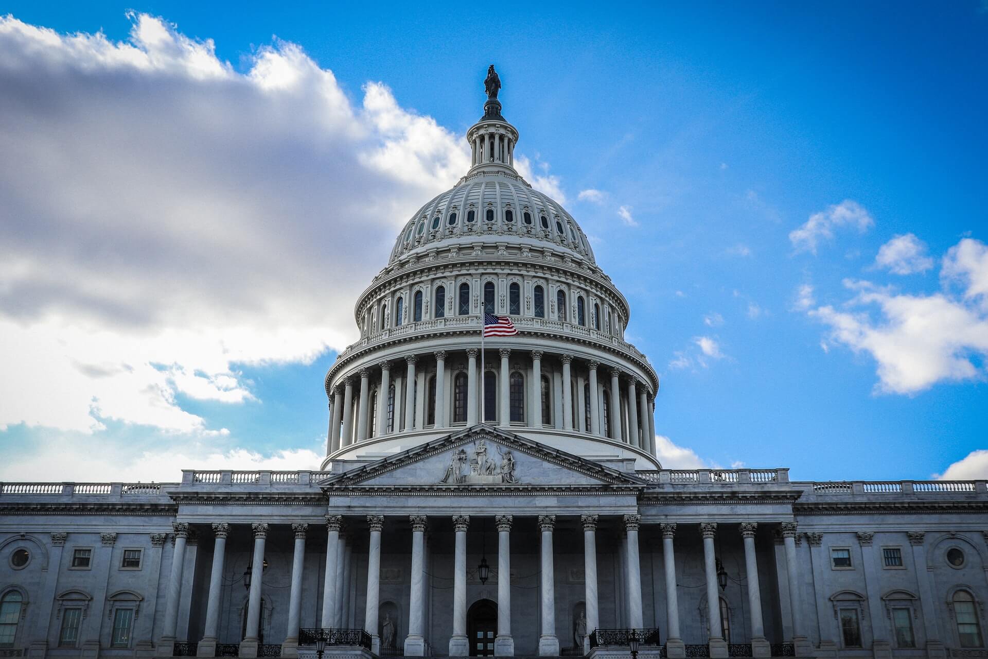 U.S. Capitol Building exterior, cloudy blue skies