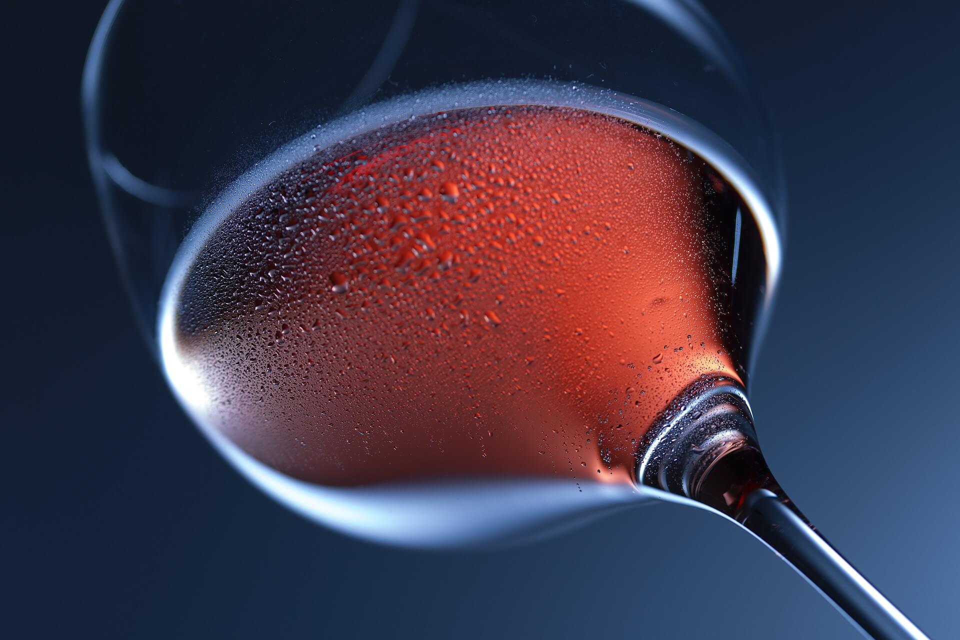 Sparkling red wine in wine glass with condensation