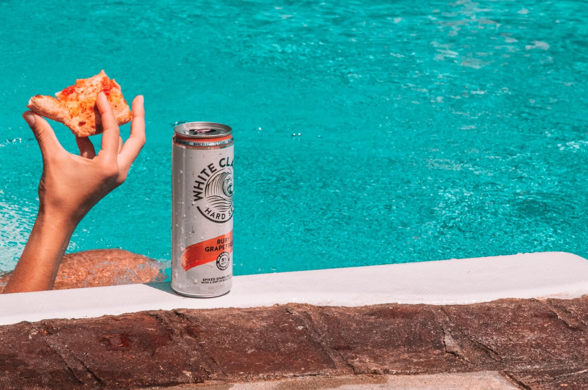 White Claw Ruby Grapefruit and pizza poolside