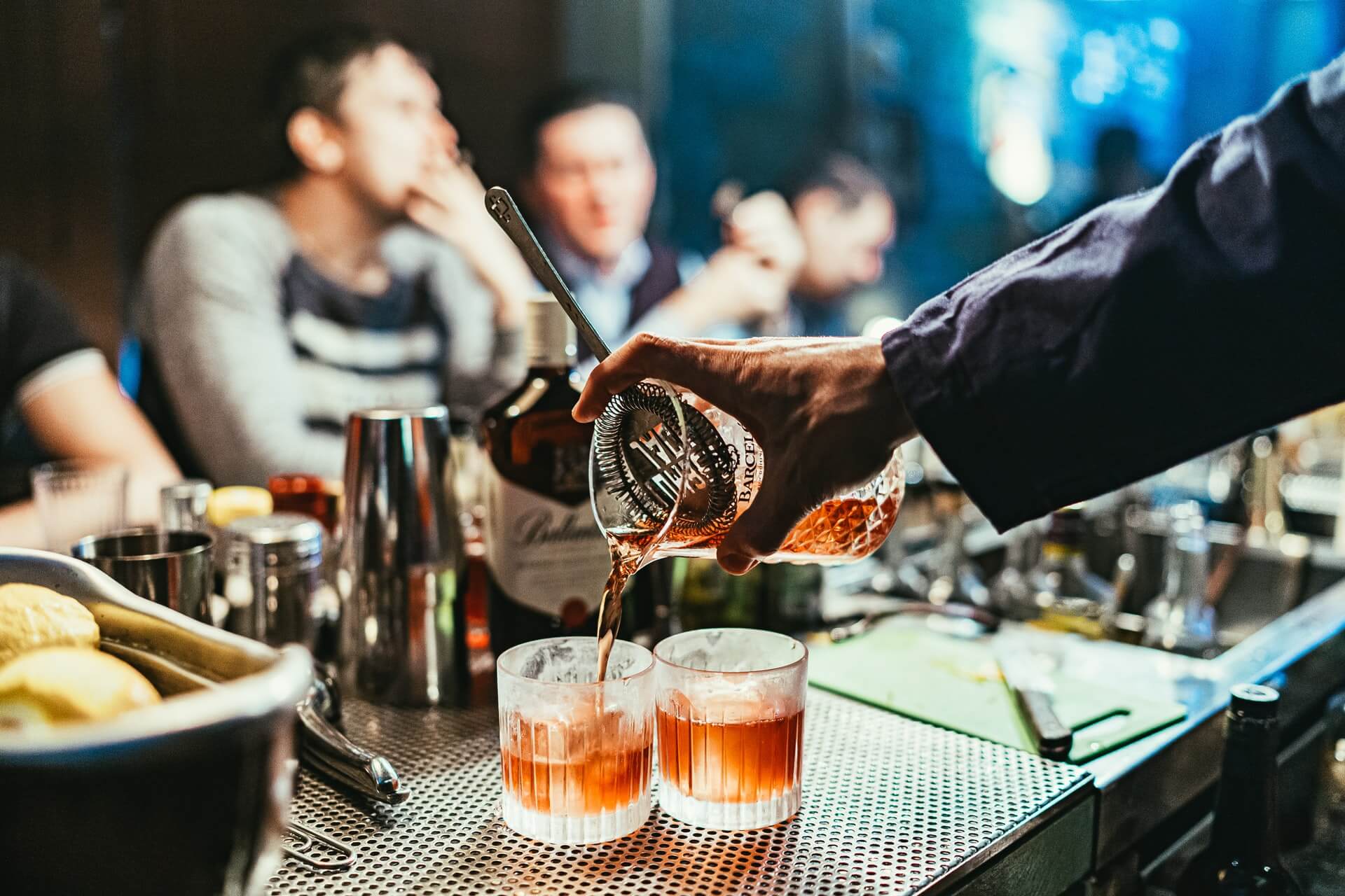 Bartender pouring cocktails on bar