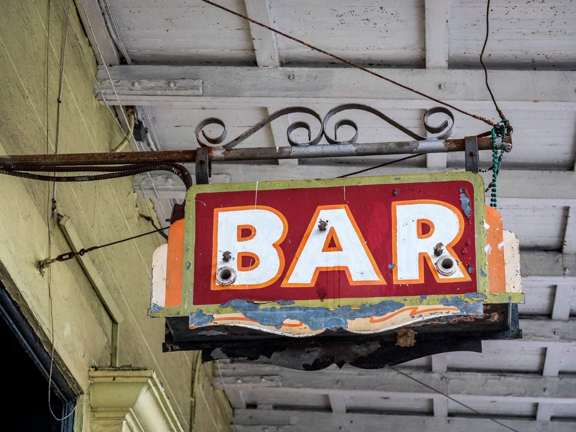 Old bar sign hanging in the French Quarter of New Orleans, Louisiana