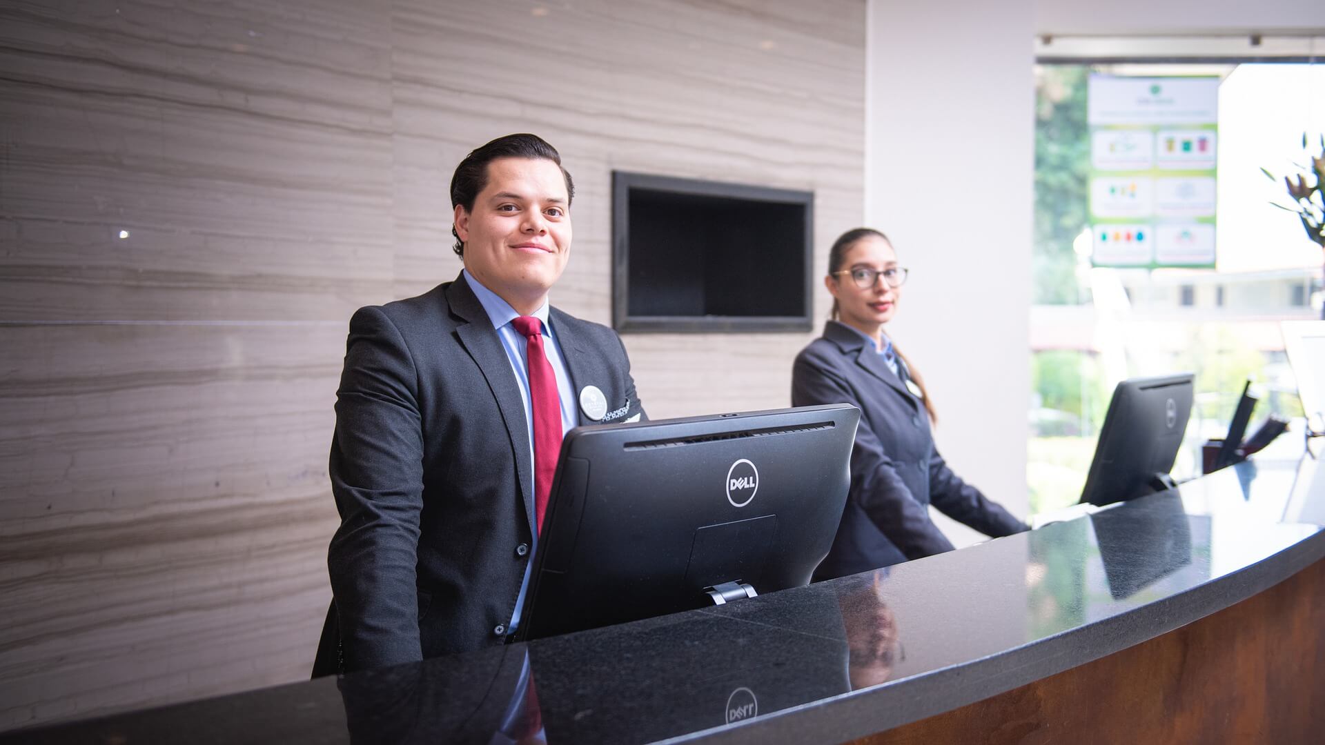 Employees at front desk in hotel lobby