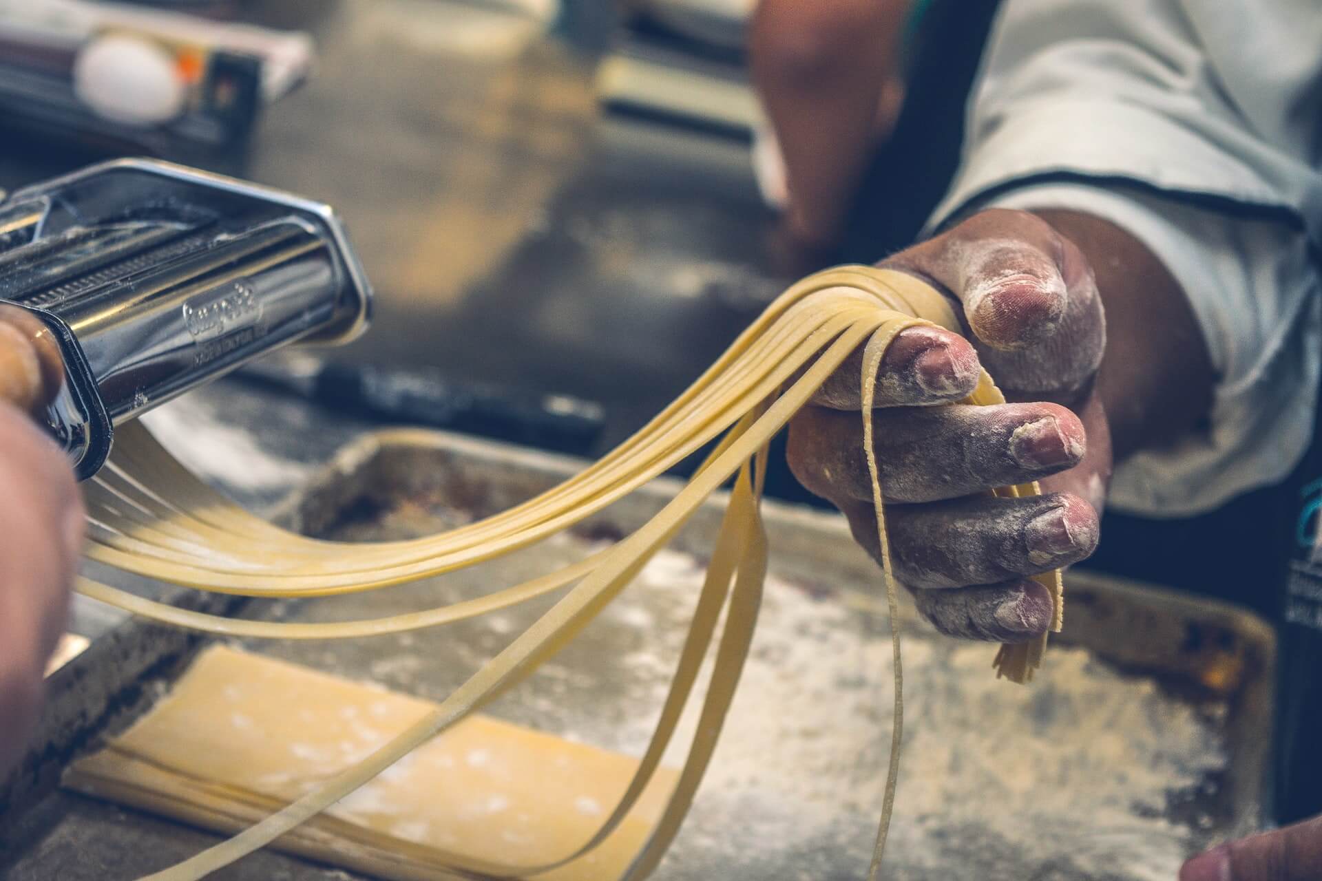 Cook making handmade pasta noodles