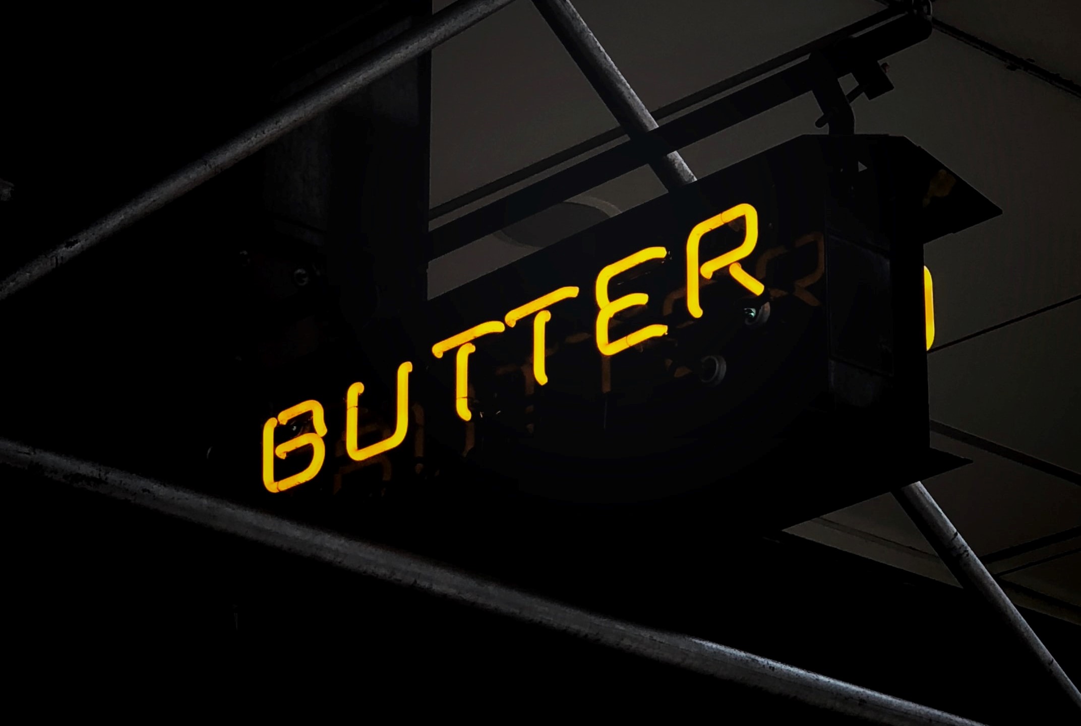 Yellow neon "butter" sign and scaffolding