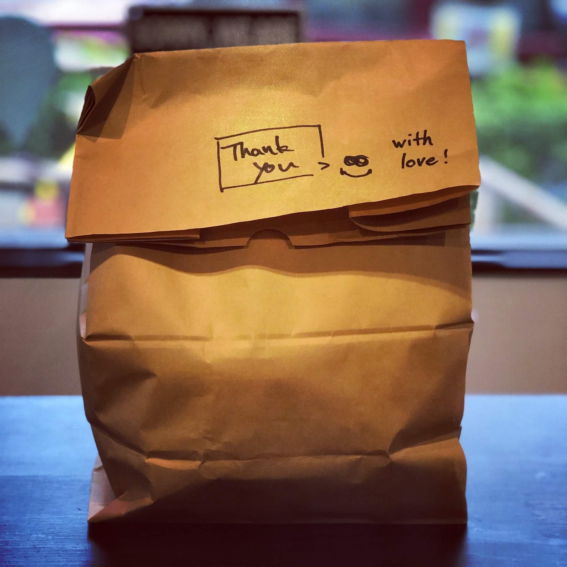 Delivery or takeout food order in brown paper bag