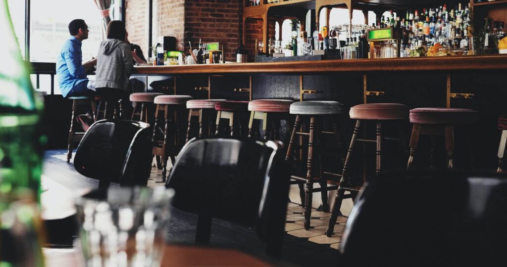 Guests sitting at the bar inside a restaurant