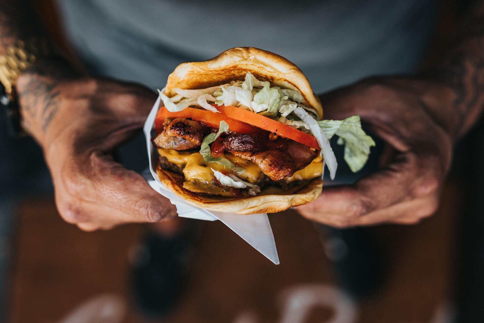 Closeup of hands holding burger