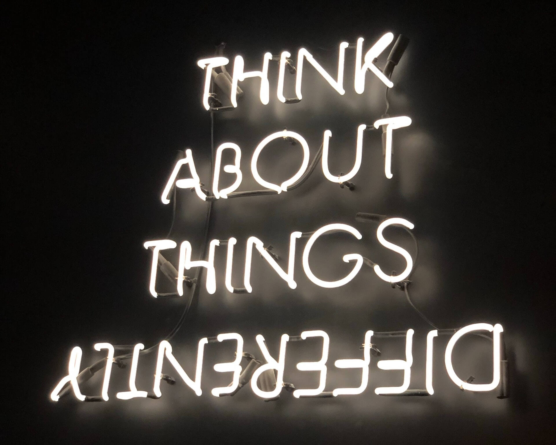 "Think about things differently" neon sign