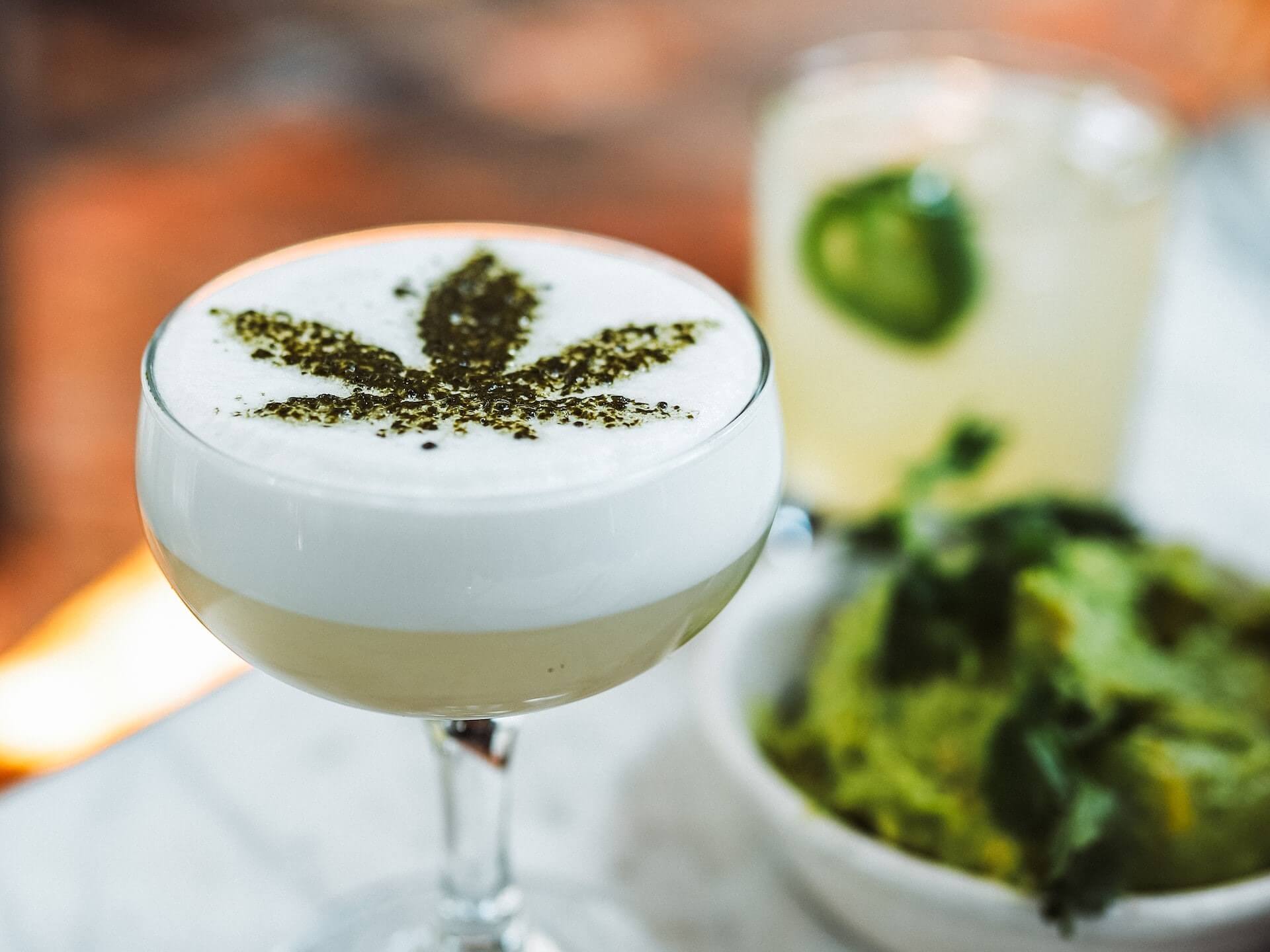 Drink with cannabis leaf artwork on top
