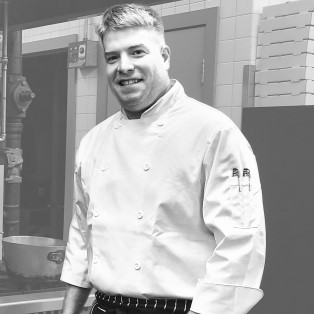 Nathen Dube, RSE, in white chef's jacket