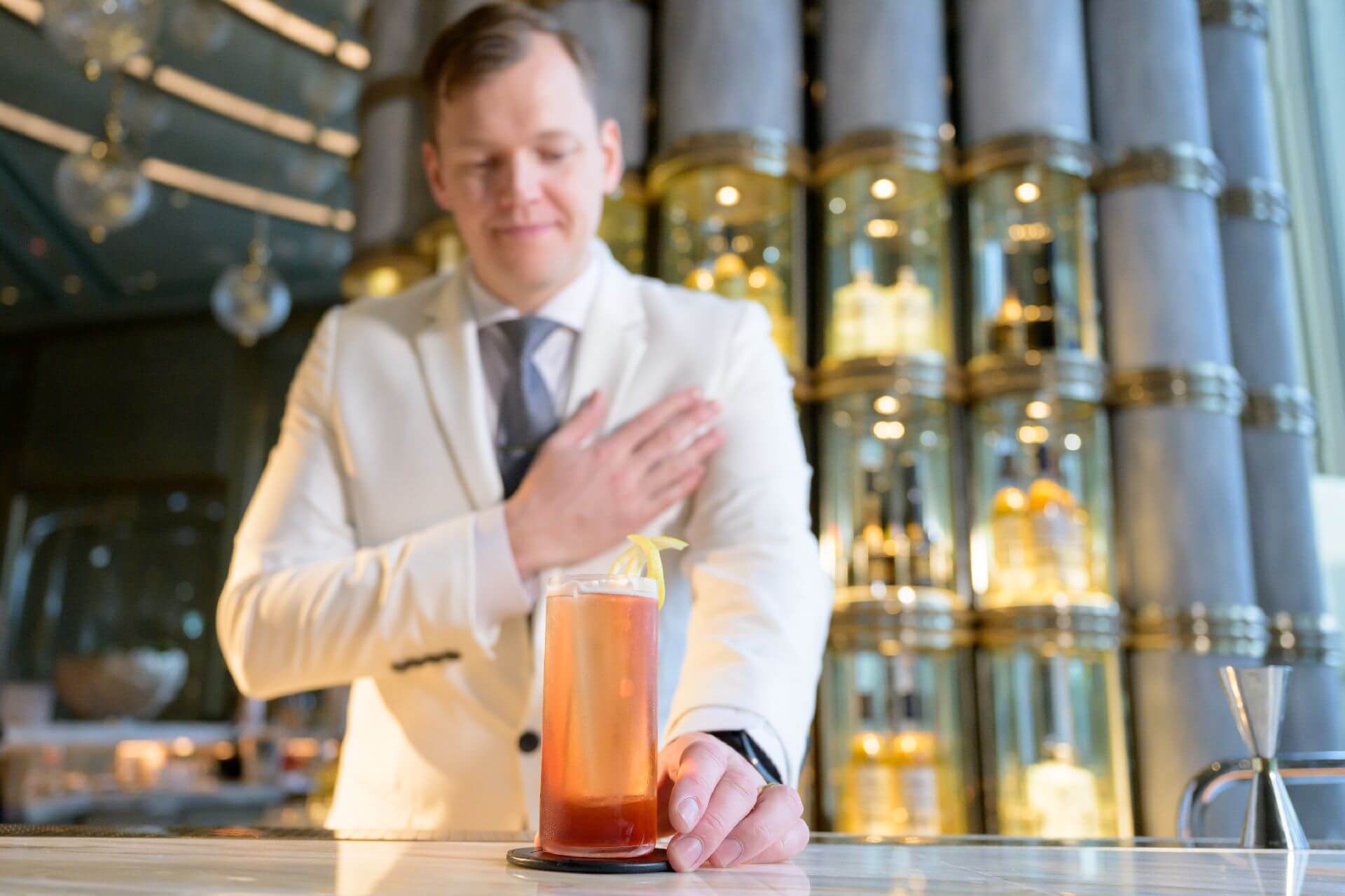 Bartender presenting cocktail in upscale setting