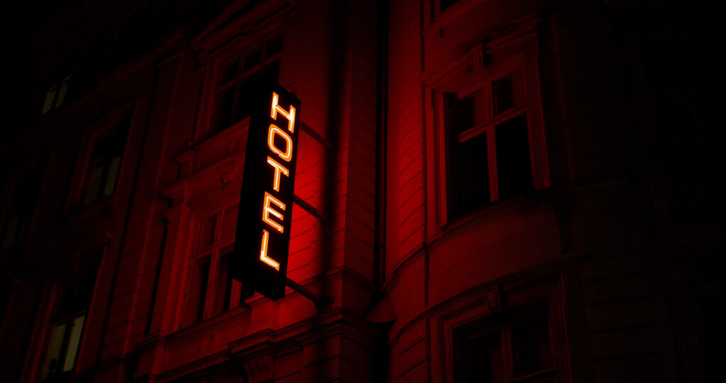 MartenBjorkRedNeonHotelSignCopenhagenUnsplash Red neon "hotel" sign in Copenhagen
