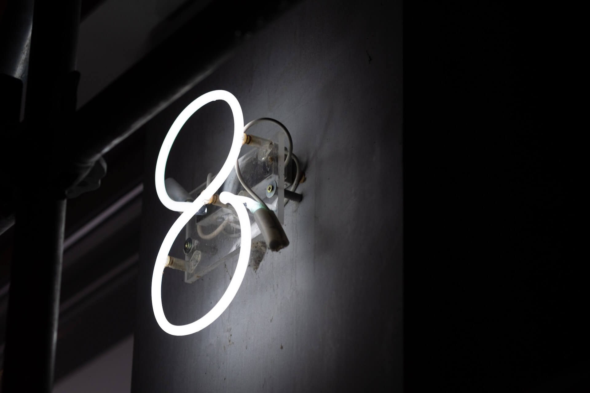 Close-up shot of a white neon "8" sign