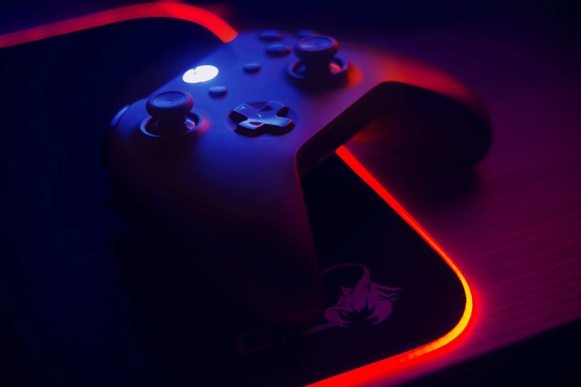 An Xbox One controller sitting on a Scorpion Gaming mouse pad