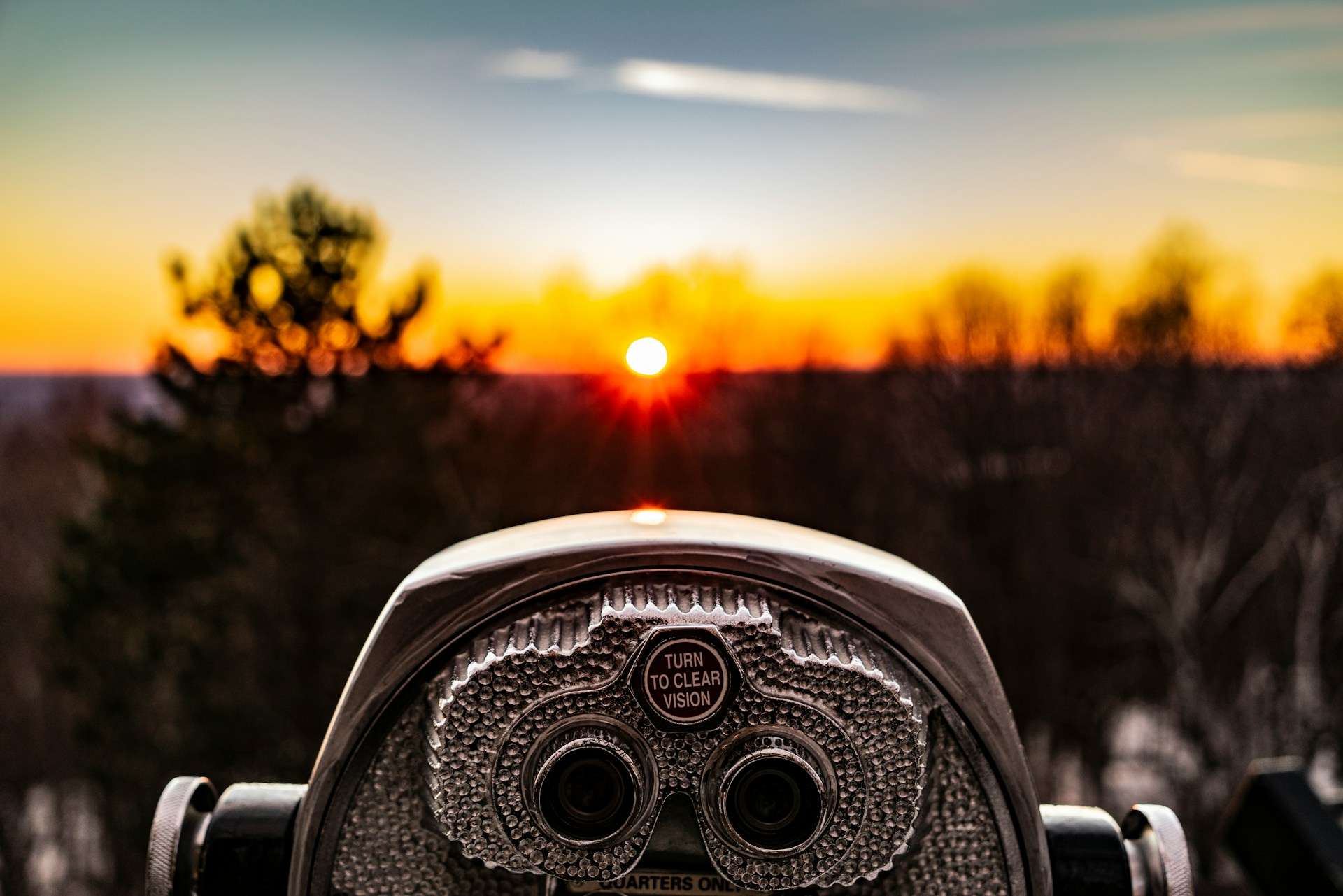 A viewing scope looking out toward a sunrise or sunset