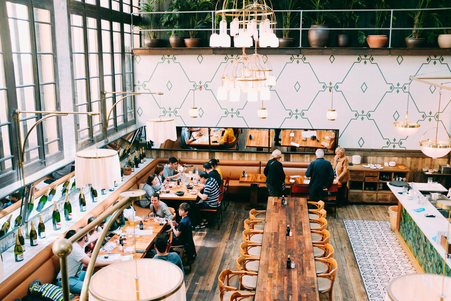 Bright, light and airy restaurant interior with communal seating across from the bar